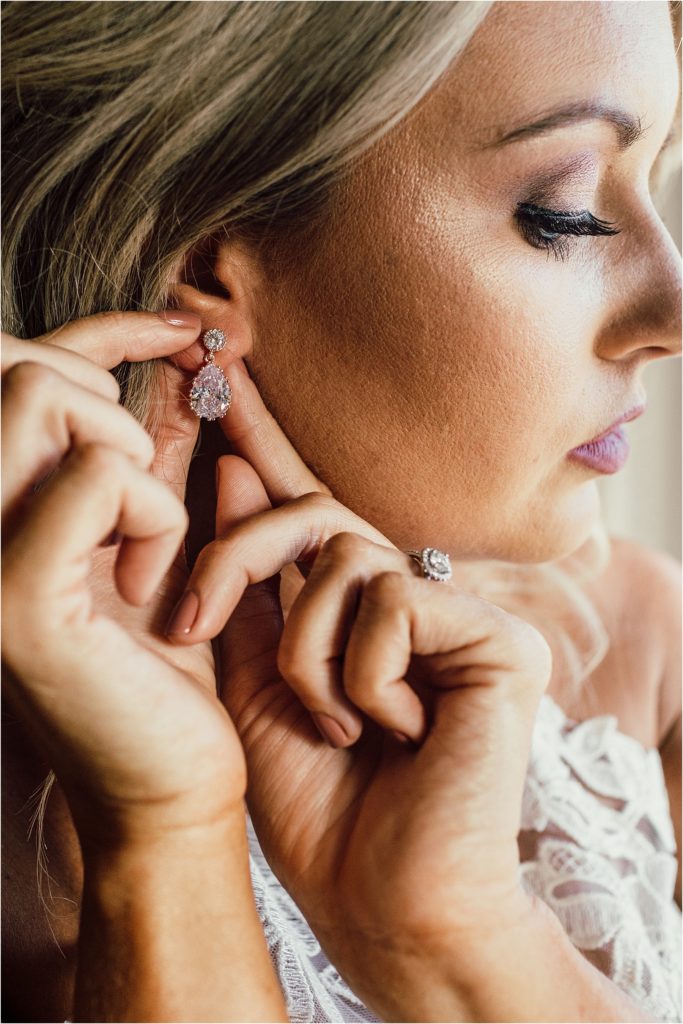 Rosemary Beach Wedding Bride Putting on Earrings Photo