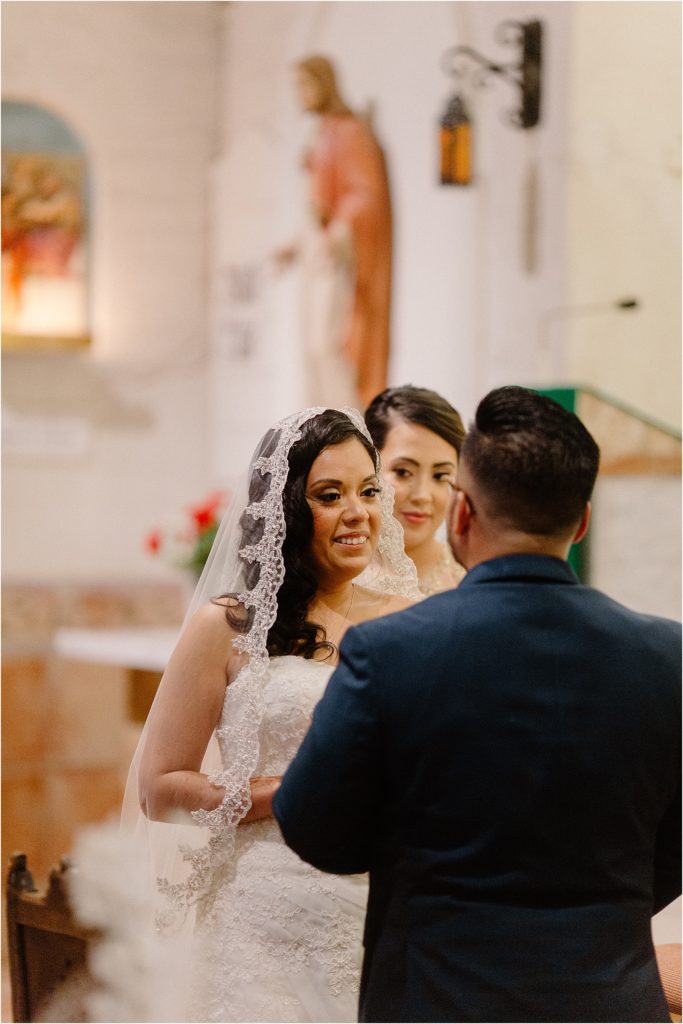 bride looking at groom inside cathedral at backyard palm springs wedding venue