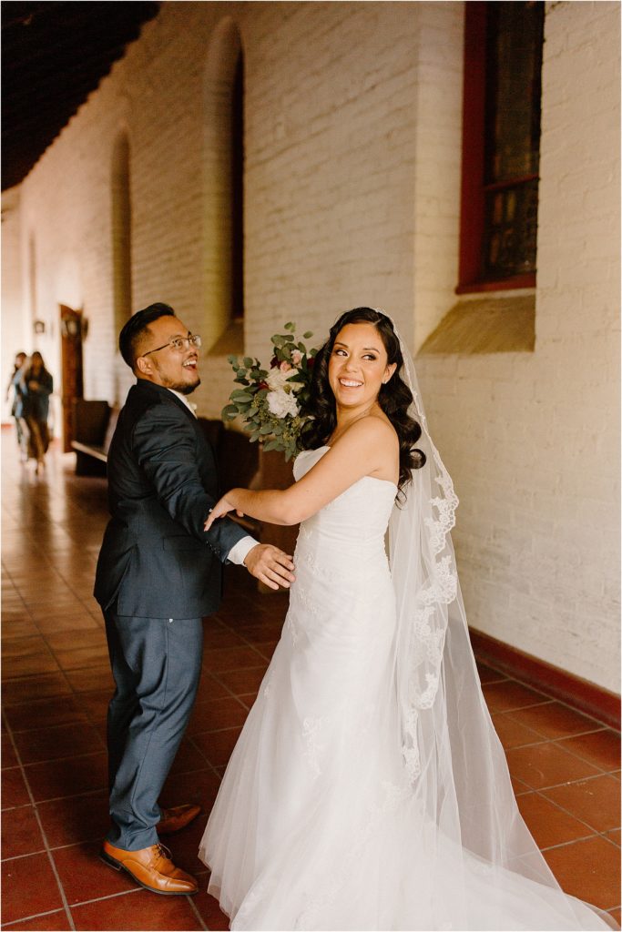 bride and groom exiting ceremony excited at backyard palm springs wedding venue