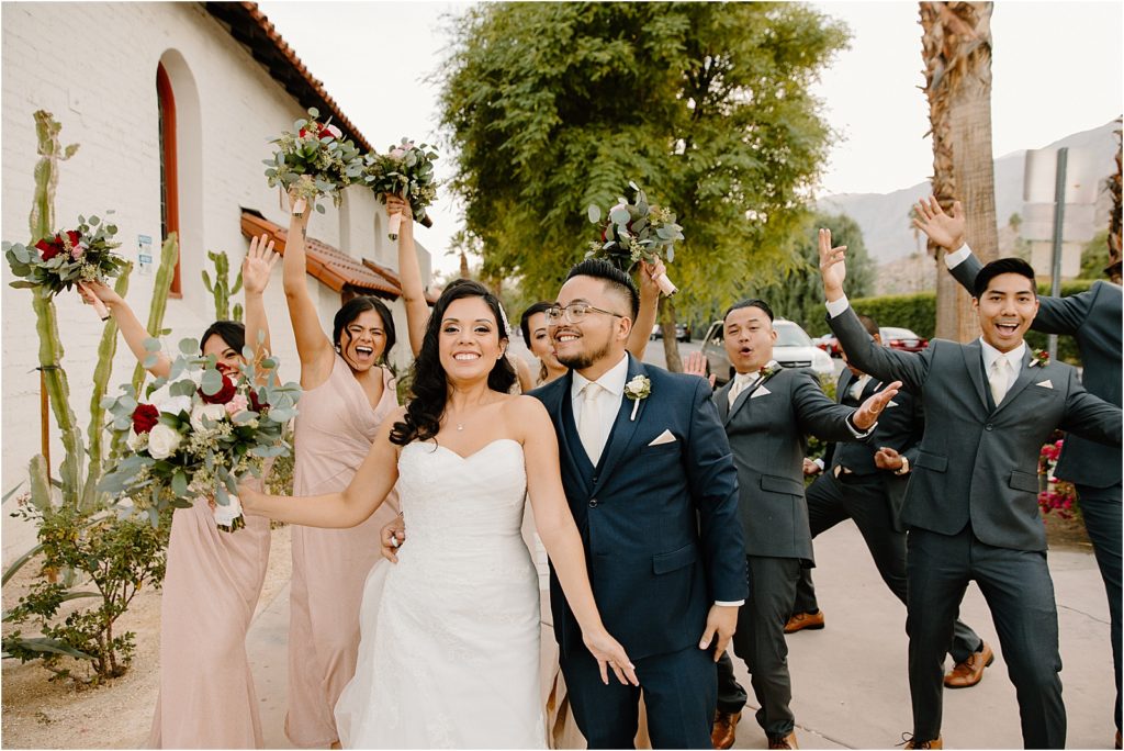 wedding party celebrating with bride and groom at backyard palm springs wedding venue