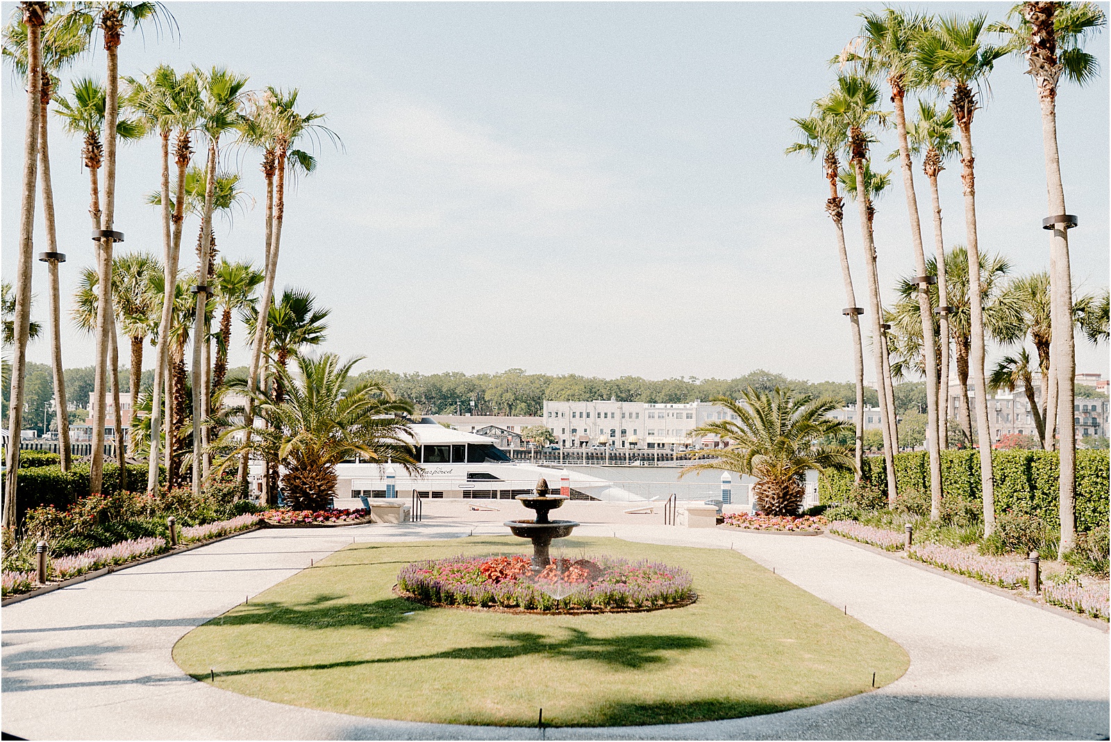 The Westin Savannah River Lawn overlooking Savannah Harbor and River Street with a yacht at the dock