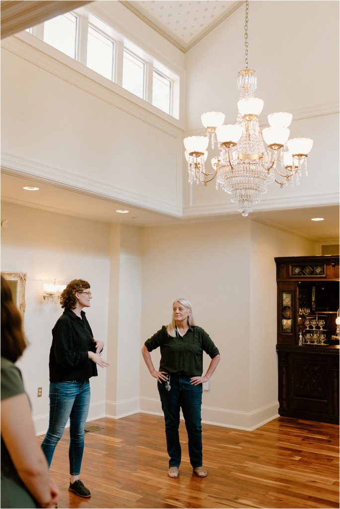 Renee and Jen exploring Gingerbread House Wedding Venue ballroom