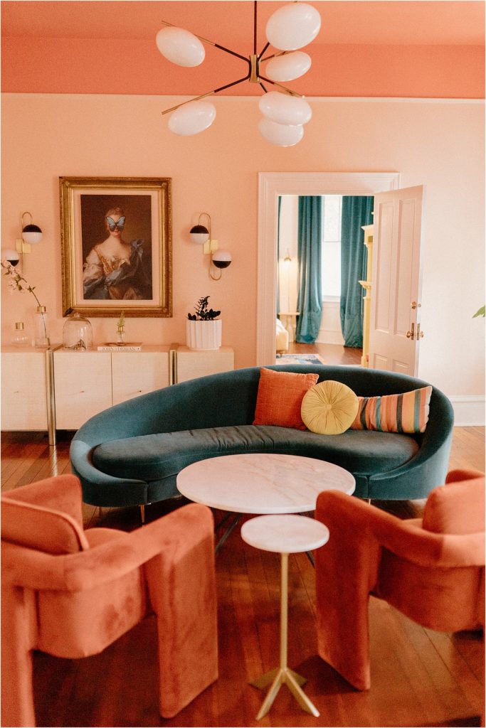 Gingerbread House Wedding Venue 
 mid centry teal sofa with pink walls