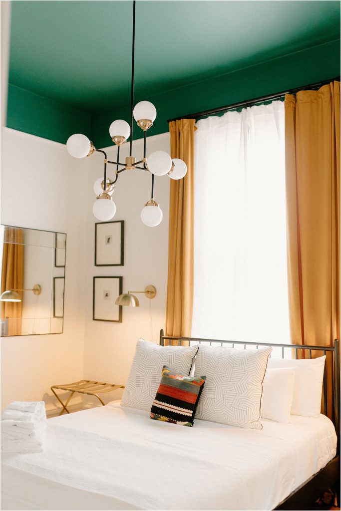 Gingerbread House Wedding Venue Secondary bedroom with yellow curtains and mid-century style